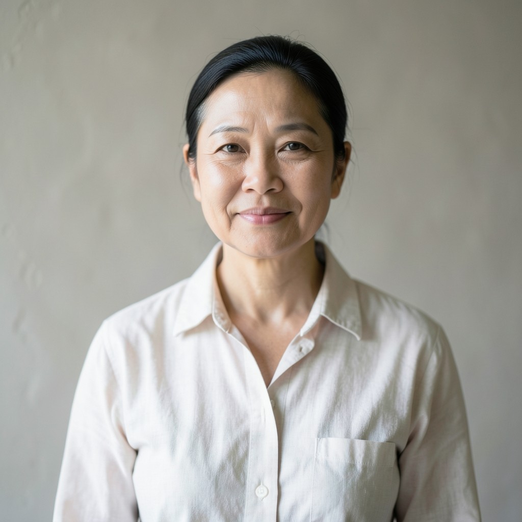 Portrait of a consulting lead in a linen shirt against a neutral wall
